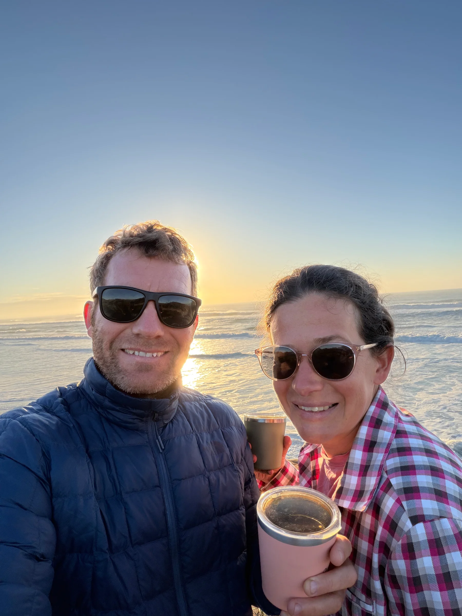Matt and Steph smiling together in warm morning light near Byron Bay