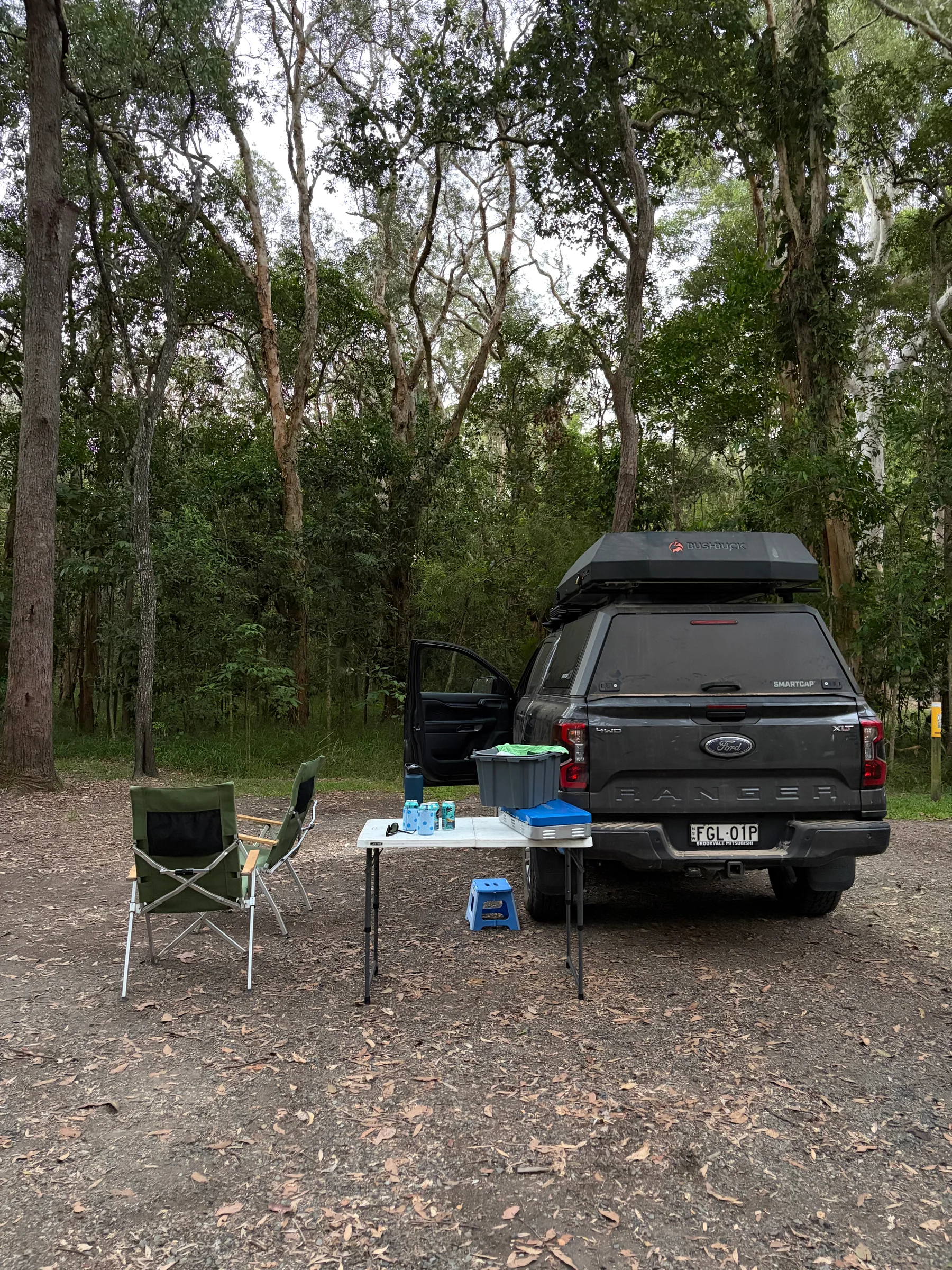 Camp table and chairs set up at the edge of Lake Cootharaba at Boreen Point.
