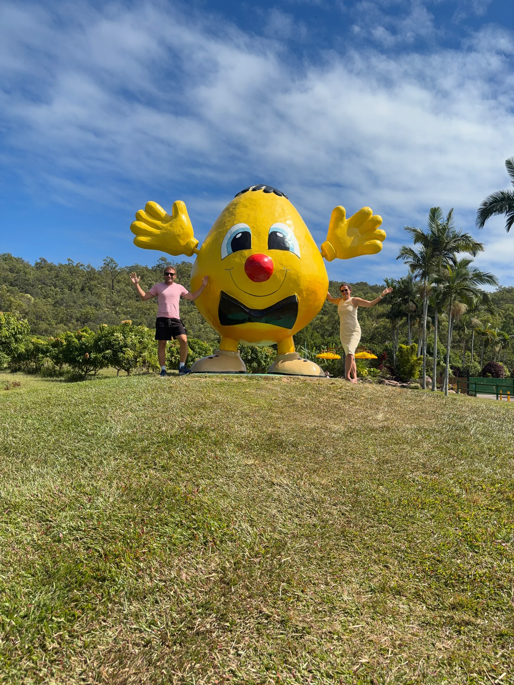 Matt and Steph posing beside the Big Mango Man at the Frosty Mango.